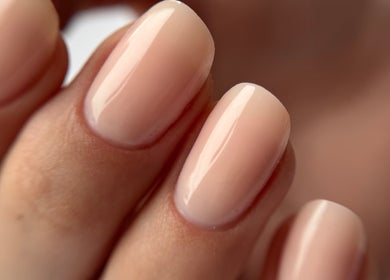 Close-up of well-groomed nails at Nail_House_by_Ilze in Rīga, LV, showcasing nude polish.