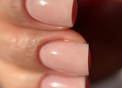 Close-up of manicured nails at Nail_House_by_Ilze, Rīga, LV showcasing a glossy nude finish.