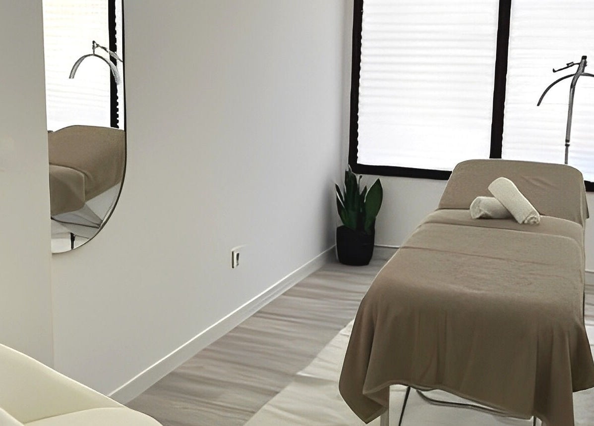 Sala de spa tranquila no B.EE Beauty & Wellness, Estarreja, Aveiro, PT, com mesa de massagem e decoração minimalista.