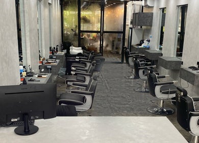 Modern barber chairs at The Barber Club Bali, Denpasar, ID with sleek interior design.