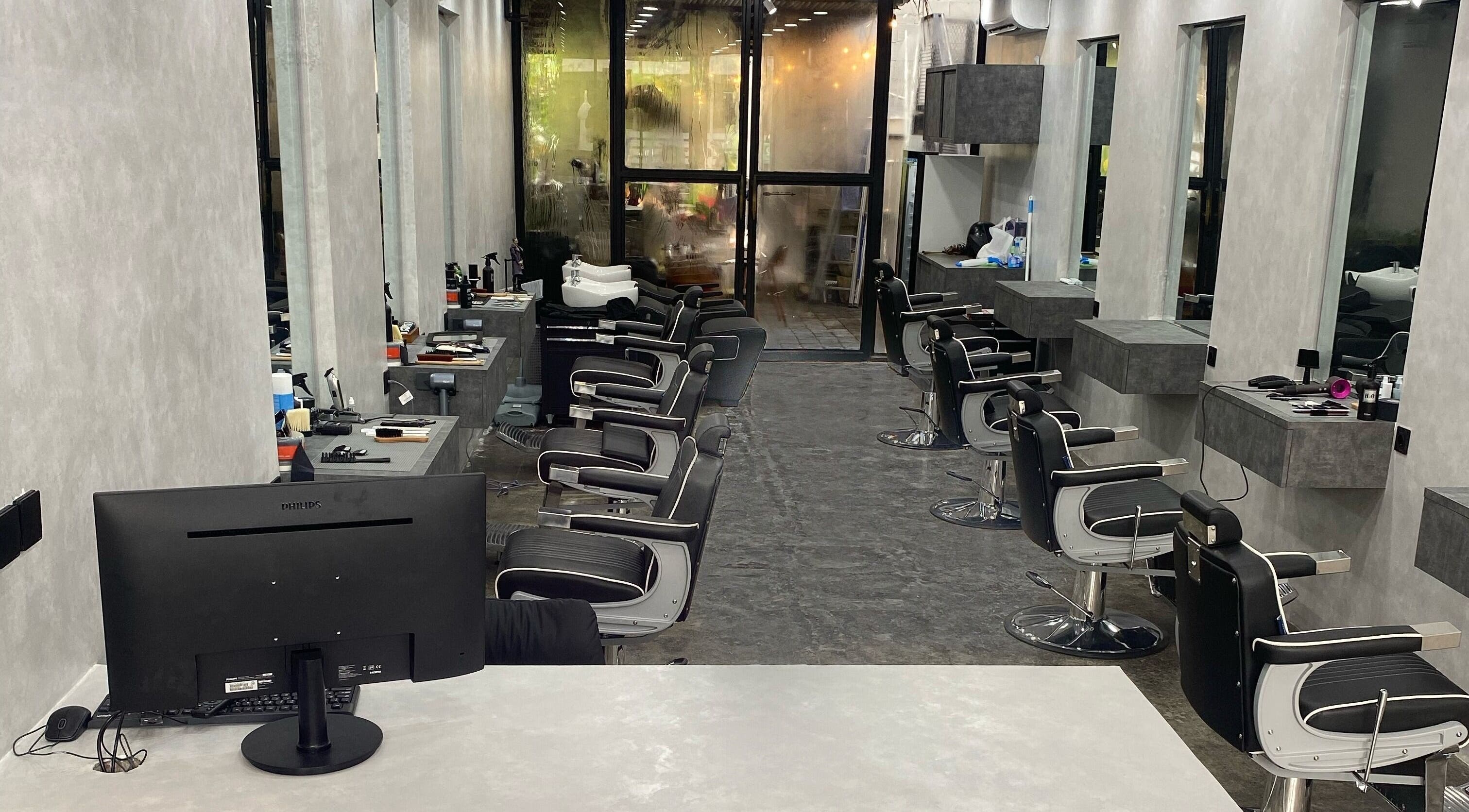 Modern barber chairs at The Barber Club Bali, Denpasar, ID with sleek interior design.