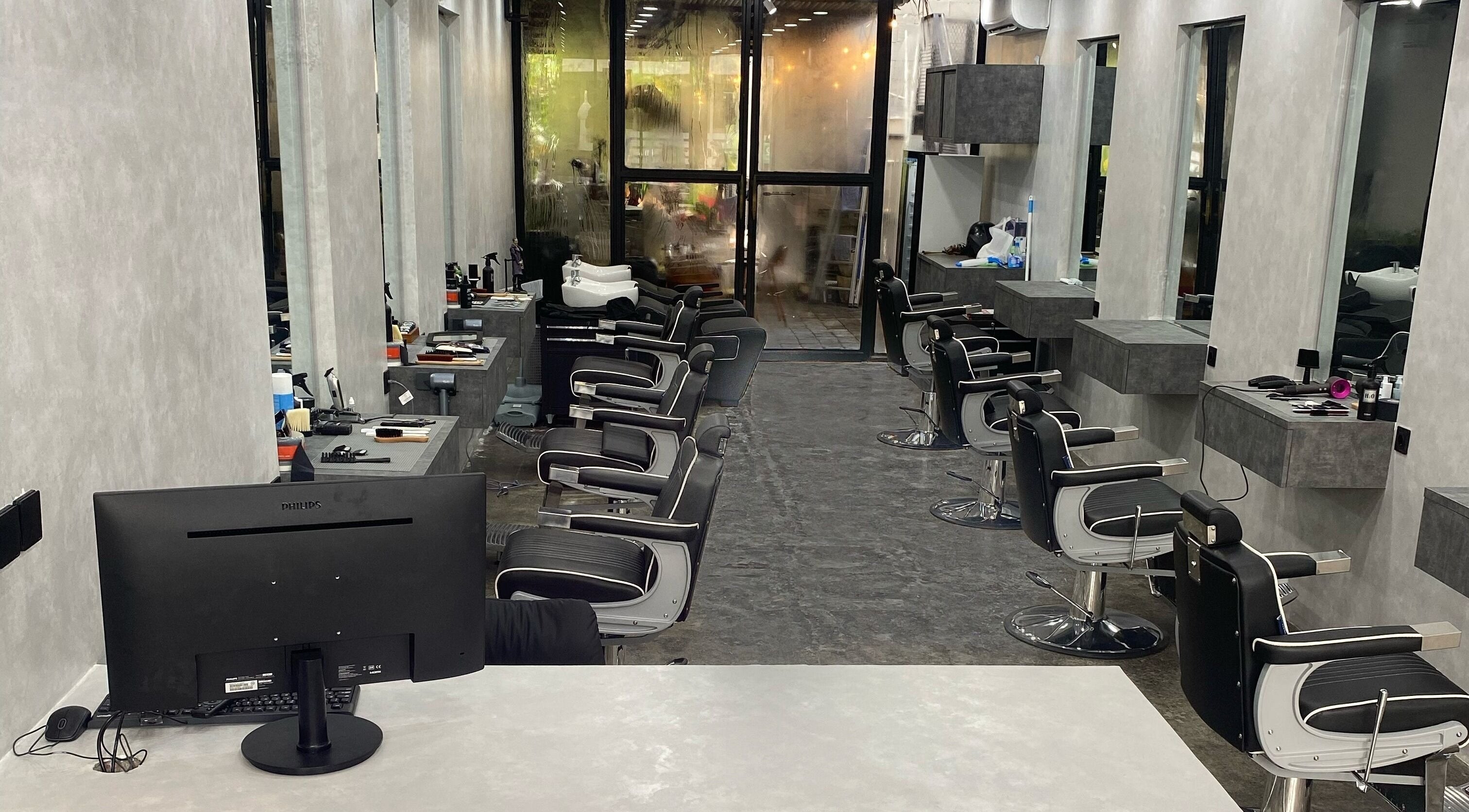 Modern barber chairs at The Barber Club Bali, Denpasar, ID with sleek interior design.