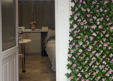 Entrance to The Glow Room in York, England, GB with floral green wall and cozy interior view.