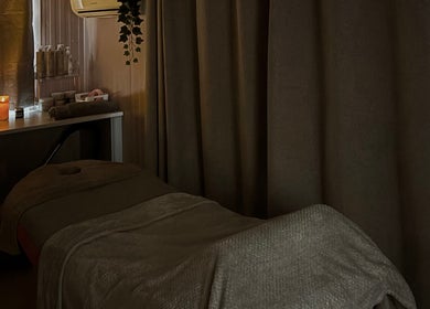 Peaceful massage room at The Glow Room, York, England, GB, with ambient candles creating a relaxing atmosphere.
