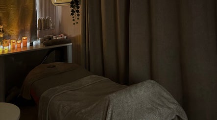 Peaceful massage room at The Glow Room, York, England, GB, with ambient candles creating a relaxing atmosphere.