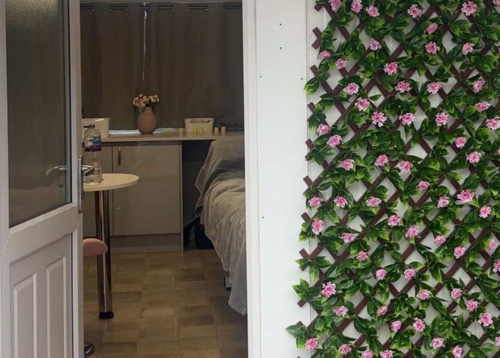 Entrance of The Glow Room in York, England with elegant floral decor on the wall.
