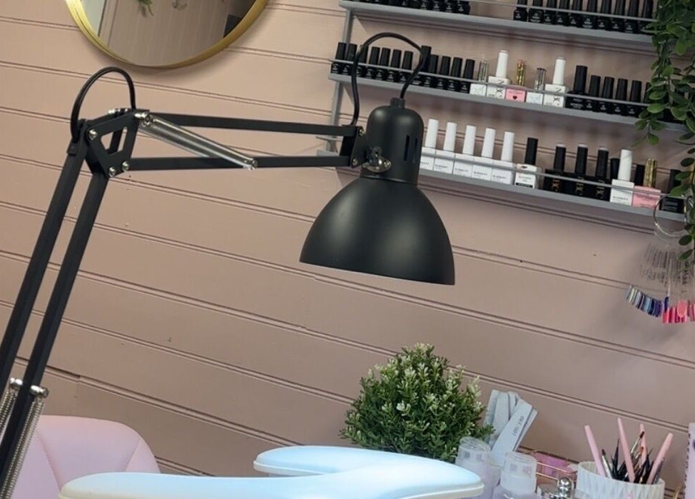 Nail station at The Glow Room, York, England, GB, featuring a lamp and nail polish display.