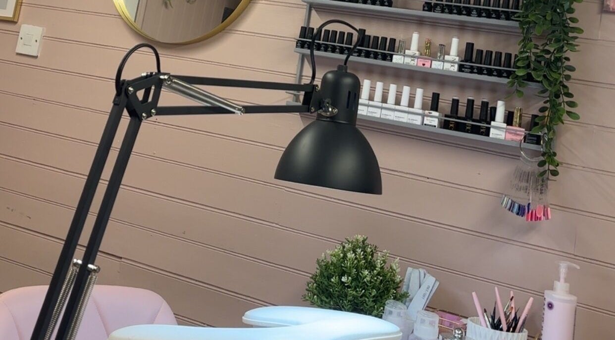 Nail station at The Glow Room, York, England, GB, featuring a lamp and nail polish display.