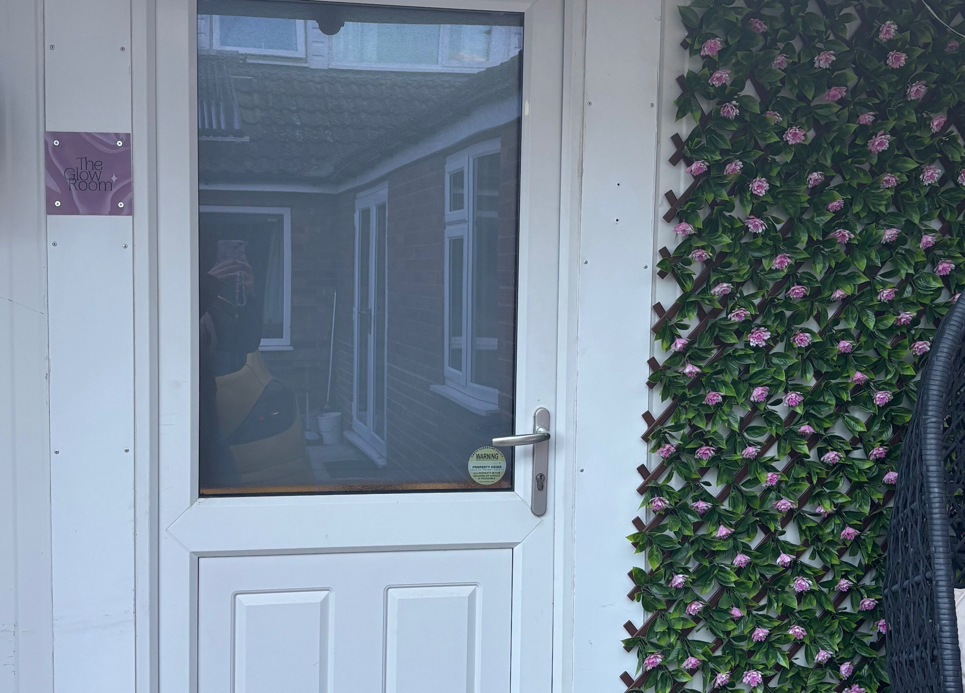 Entrance of The Glow Room, York, England, GB with floral decor and cozy ambiance.
