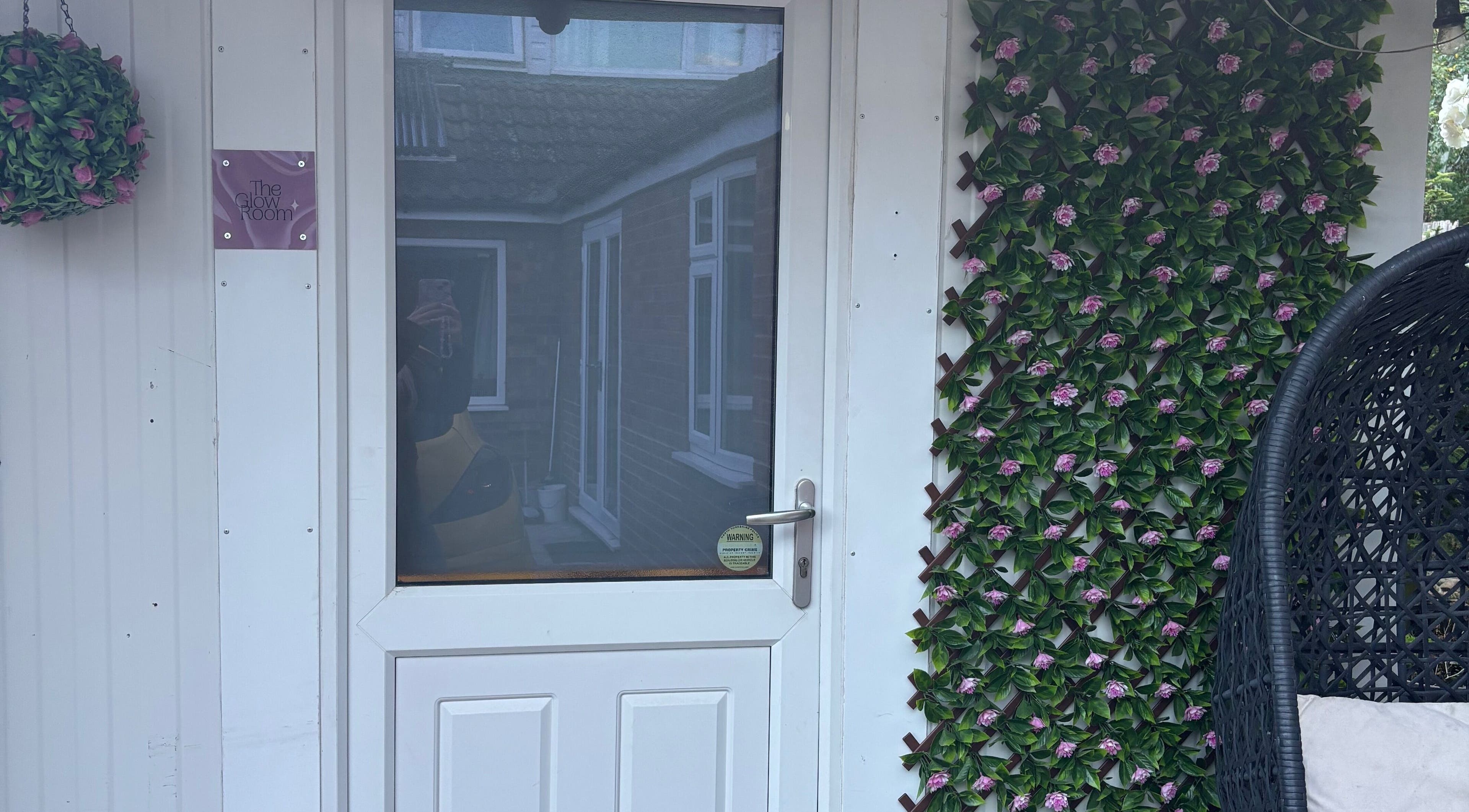 Entrance of The Glow Room, York, England, GB with floral decor and cozy ambiance.