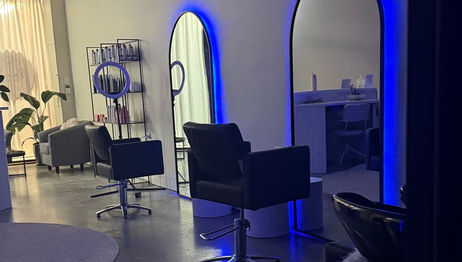Modern salon interior at Beau.Te Hair & Co, Melbourne, Victoria, AU with stylish chairs and ambient lighting.