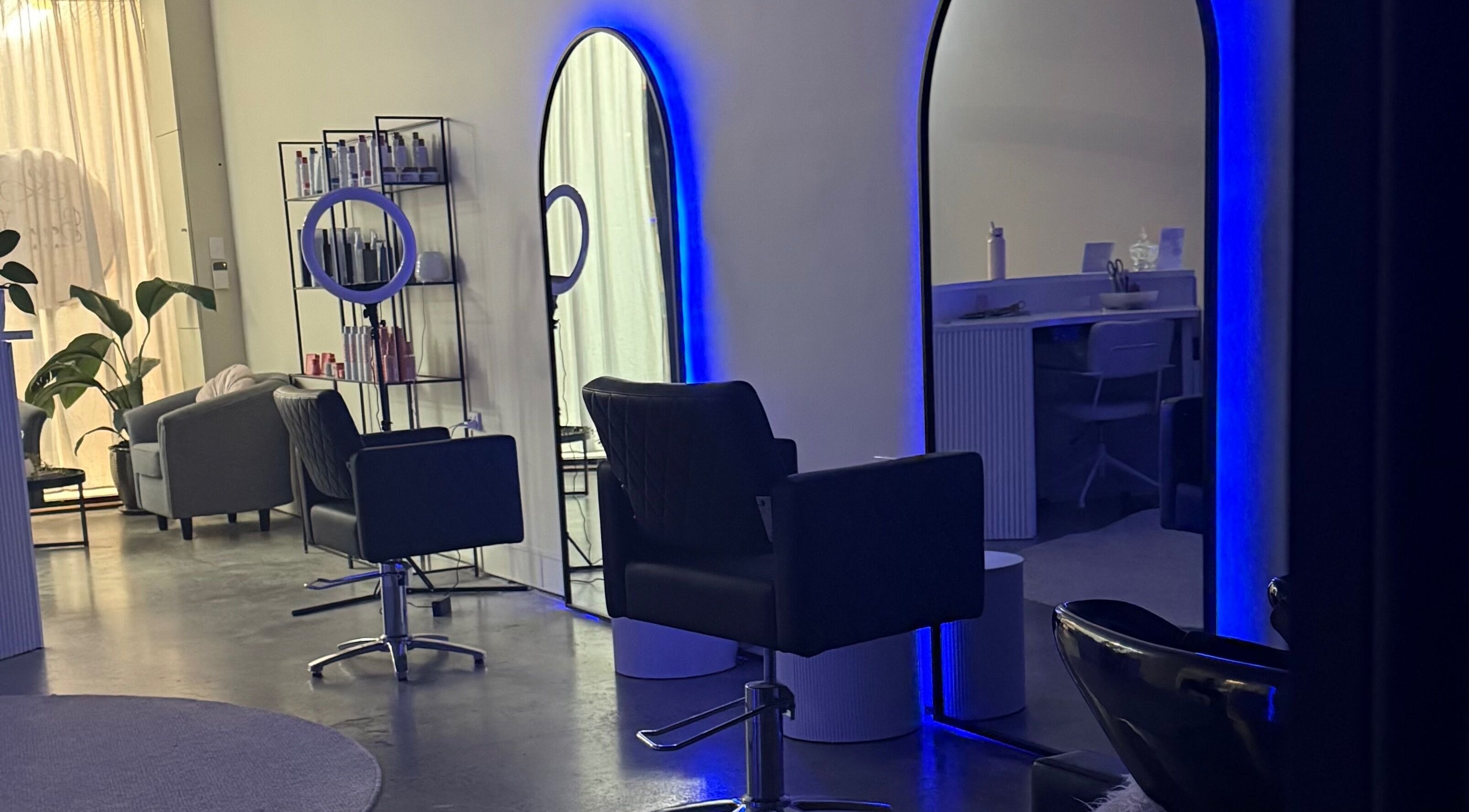 Modern salon interior at Beau.Te Hair & Co, Melbourne, Victoria, AU with stylish chairs and ambient lighting.