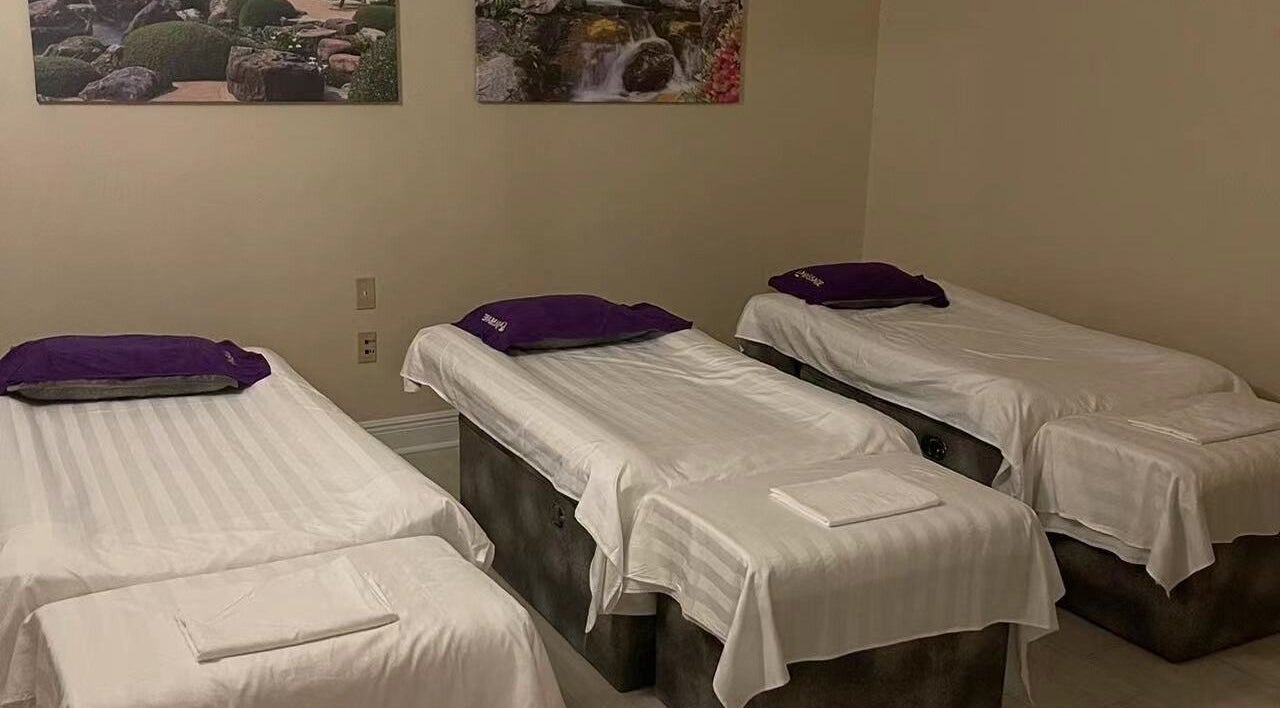 Serene massage room with three beds at Gravier Street Massage in New Orleans, Louisiana, US.