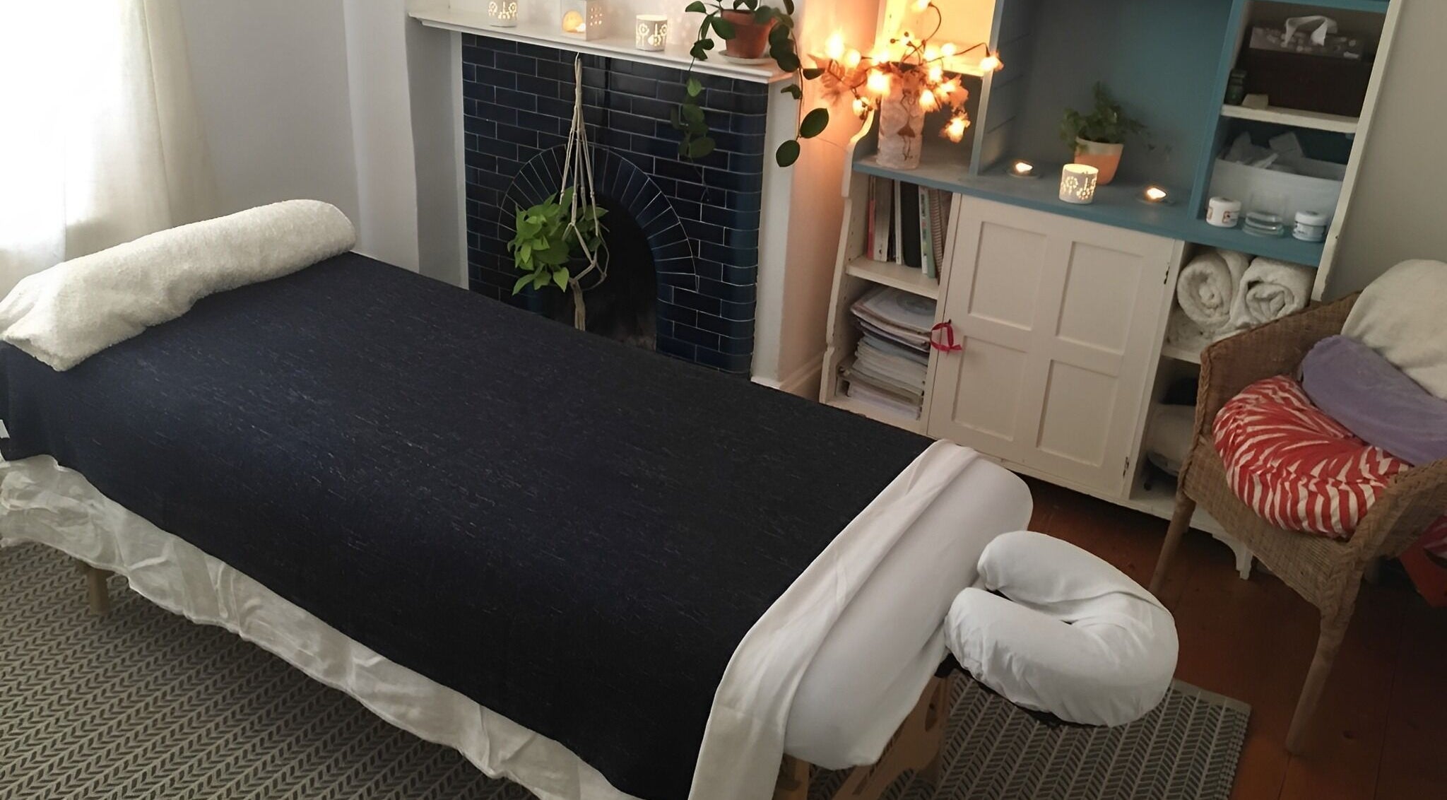 Peaceful massage room at Sion Therapies, Bristol, England, GB, featuring a cozy massage table and calming decor.