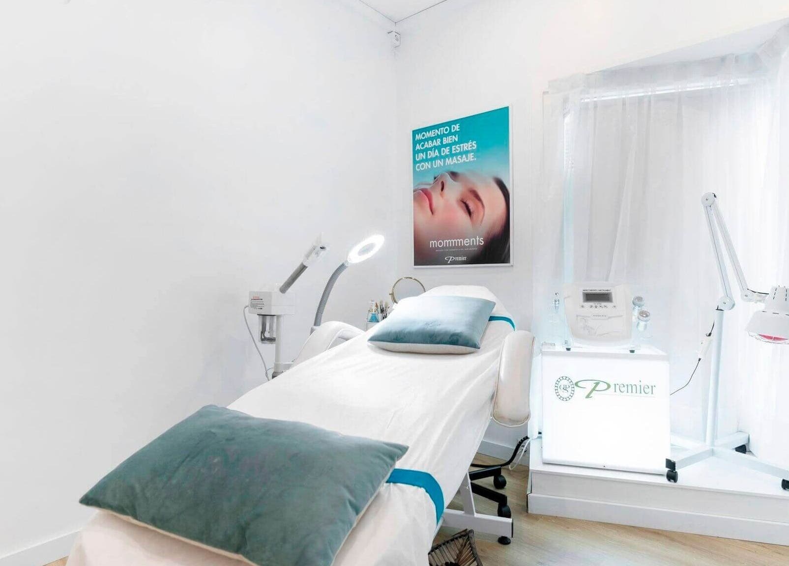 Sala de tratamientos en Premier Sitges, Sitges, Catalunya, ES con cama y equipo estético iluminado.