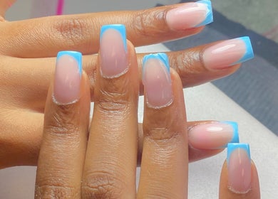 Stylish blue-tipped manicure at Biromi Nails & Beauty, Boksburg, Gauteng, ZA, showcasing expert nail artistry.