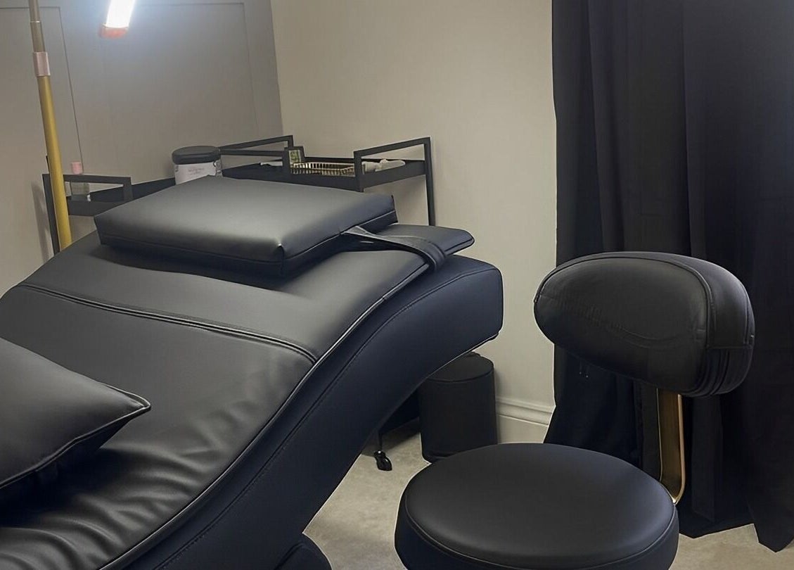 Luxury treatment room at Xlashedbykatiex in Ponteland, England, GB featuring a sleek black chair and modern decor.