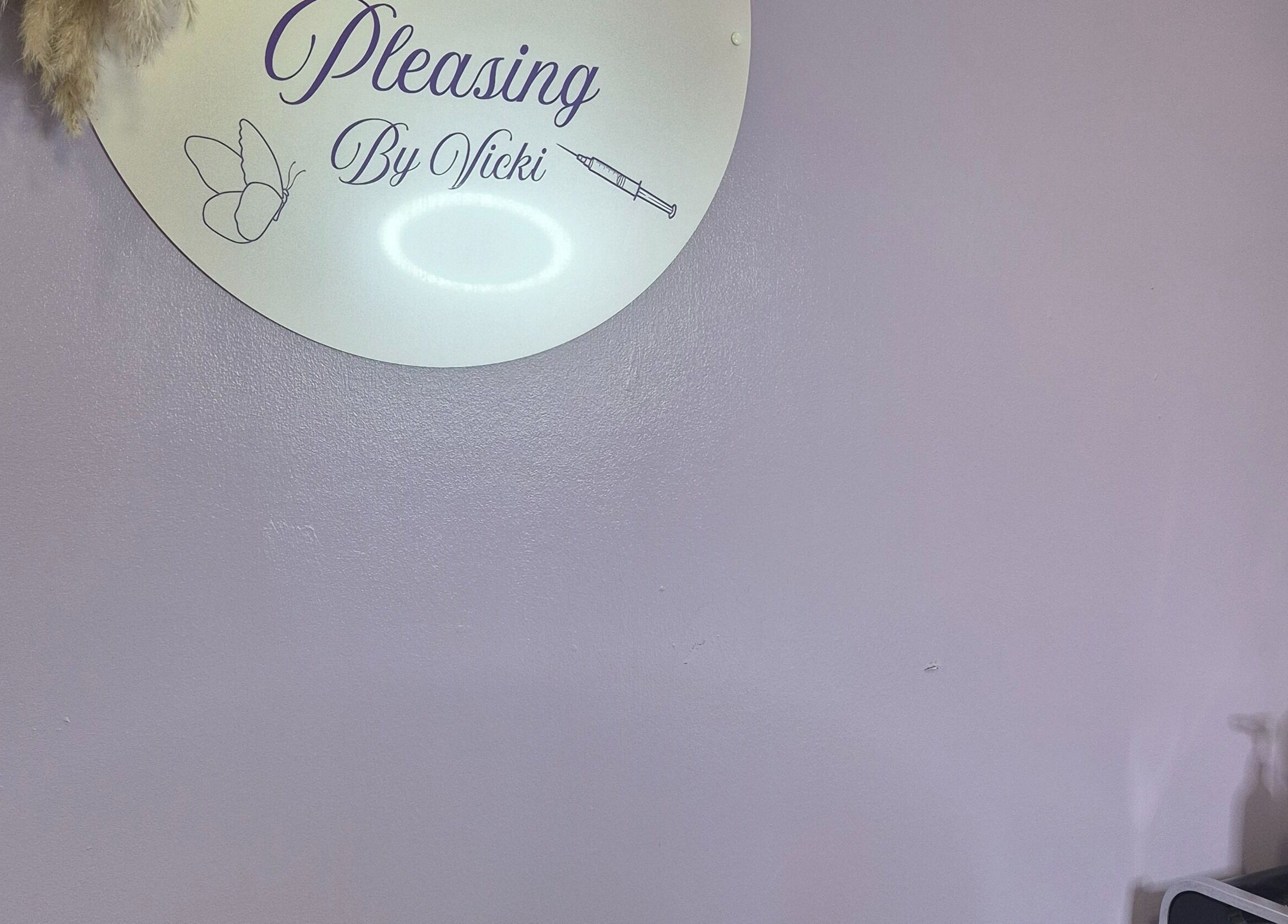 Elegant wall sign at Aestheticly Pleasing By Vicki, Rutherglen, Scotland, GB with beauty products.