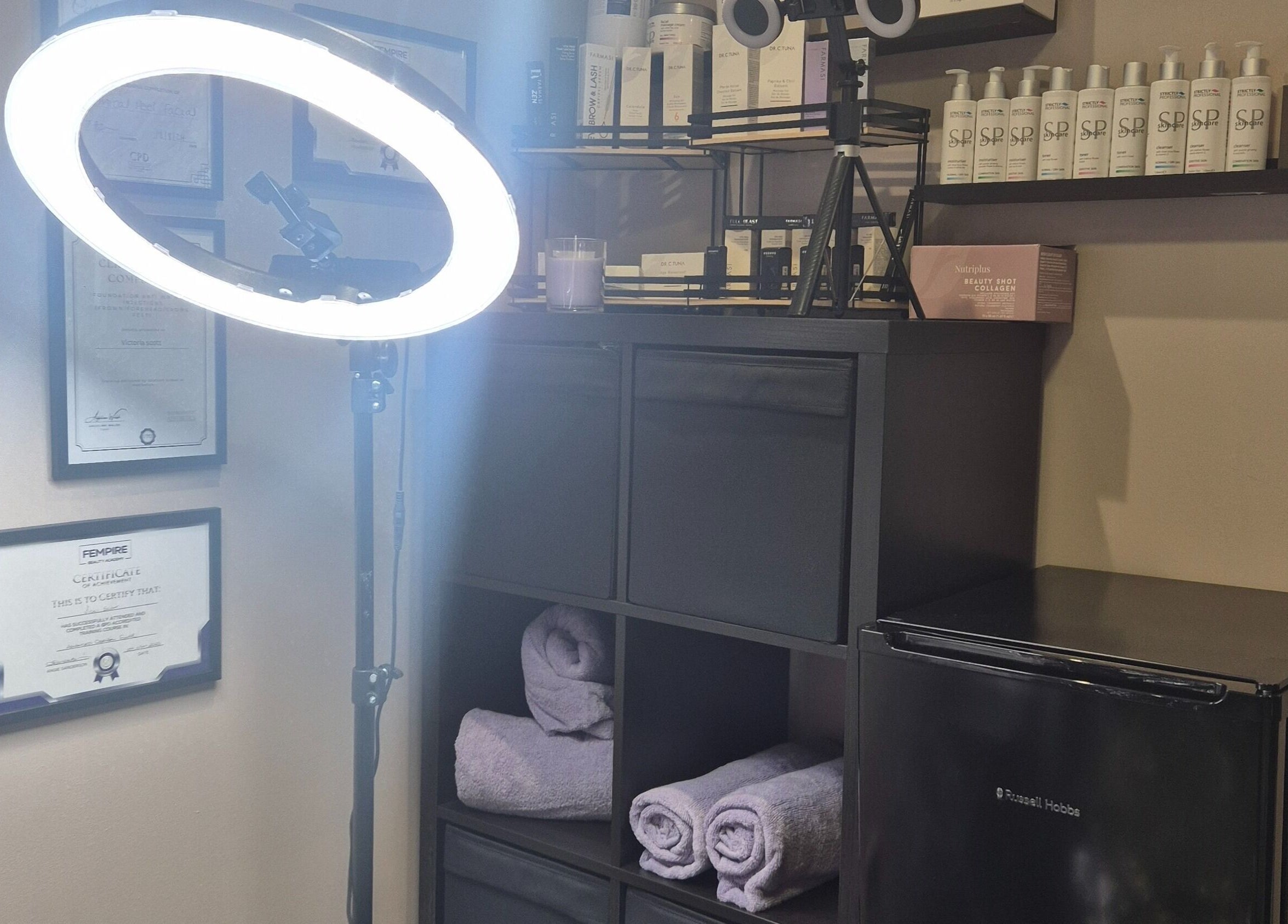 Well-organized beauty corner at Aestheticly Pleasing By Vicki, Rutherglen, Scotland, GB, featuring products and towels.