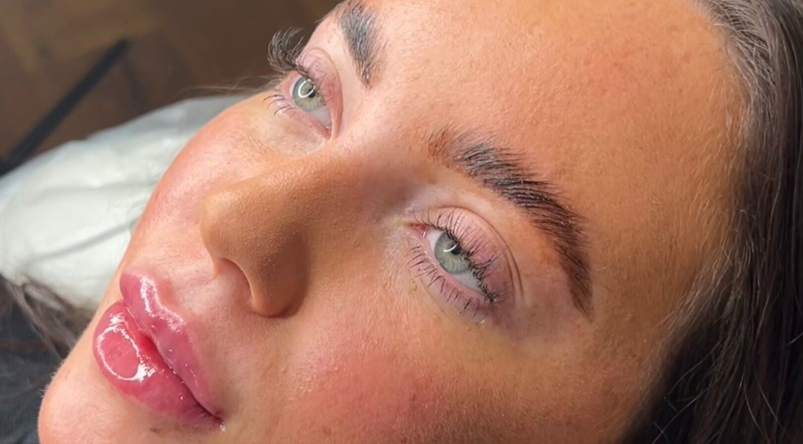 Close-up of a woman's face with perfect skin and lashes at Luna Aesthetics & Beauty in Otley, England, GB.