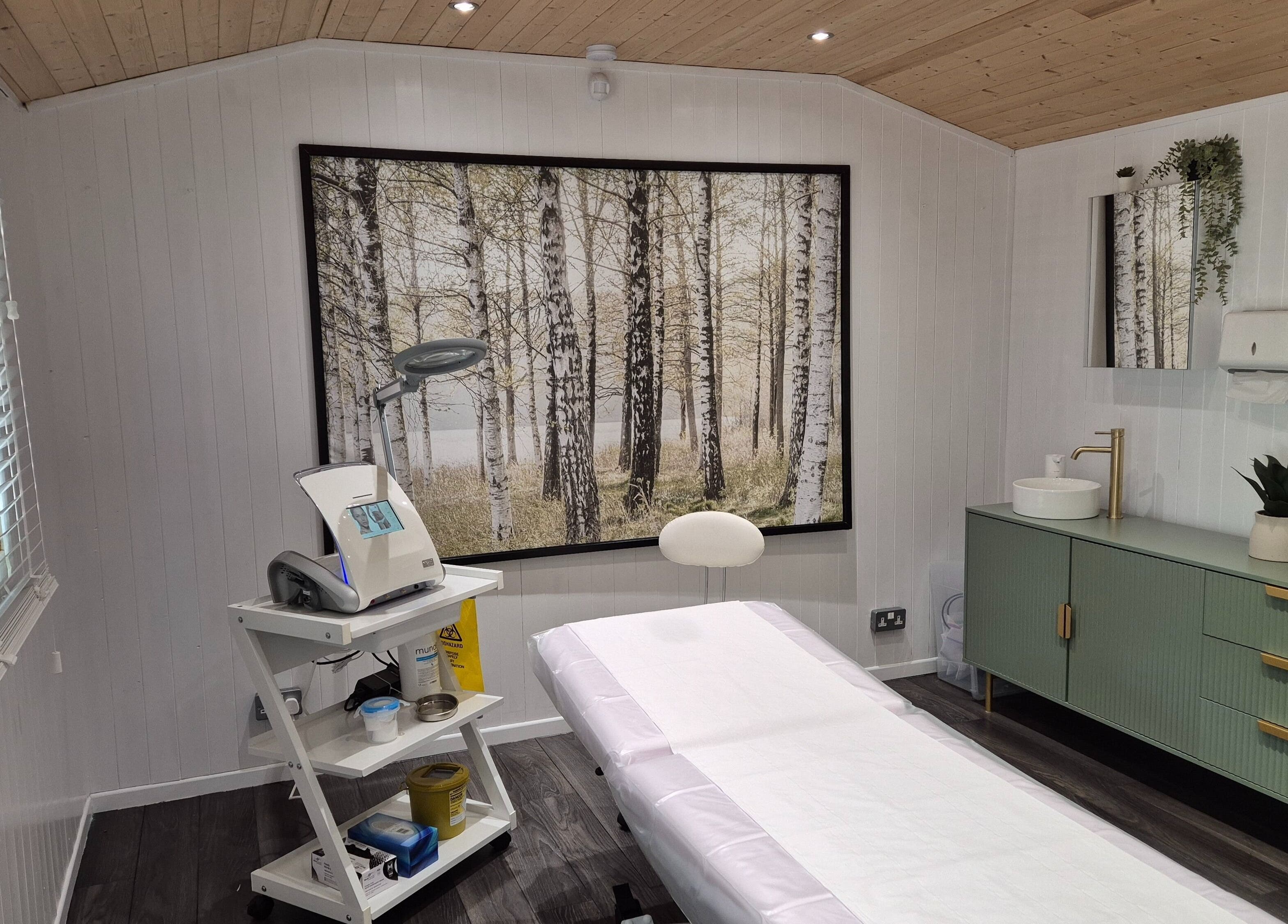 Sleek treatment room at ElectroGlow Studio, Well Hill, England with a tranquil forest mural.
