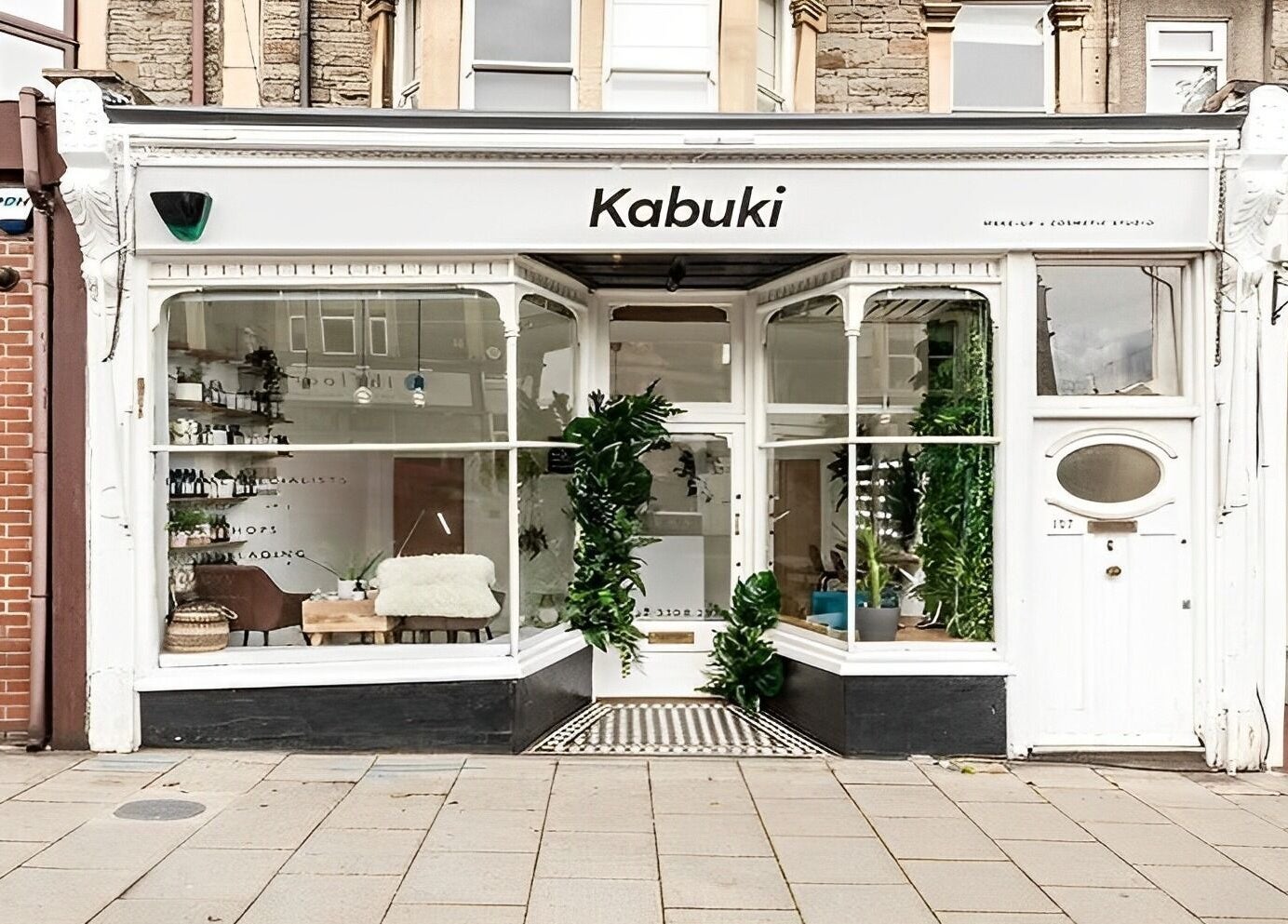 Exterior view of Kabuki Studios in Bristol, England, GB, showcasing elegant storefront and lush greenery.