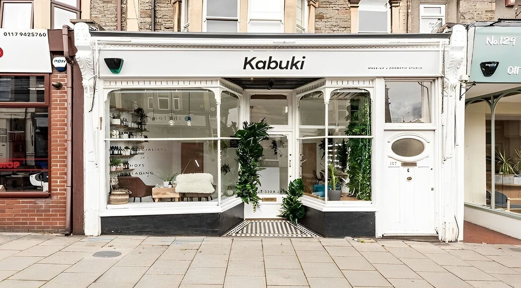 Exterior view of Kabuki Studios in Bristol, England, GB, showcasing elegant storefront and lush greenery.