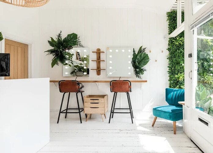 Bright beauty space at Kabuki Studios, Bristol, England, GB with mirrors, chairs, and lush greenery decor.