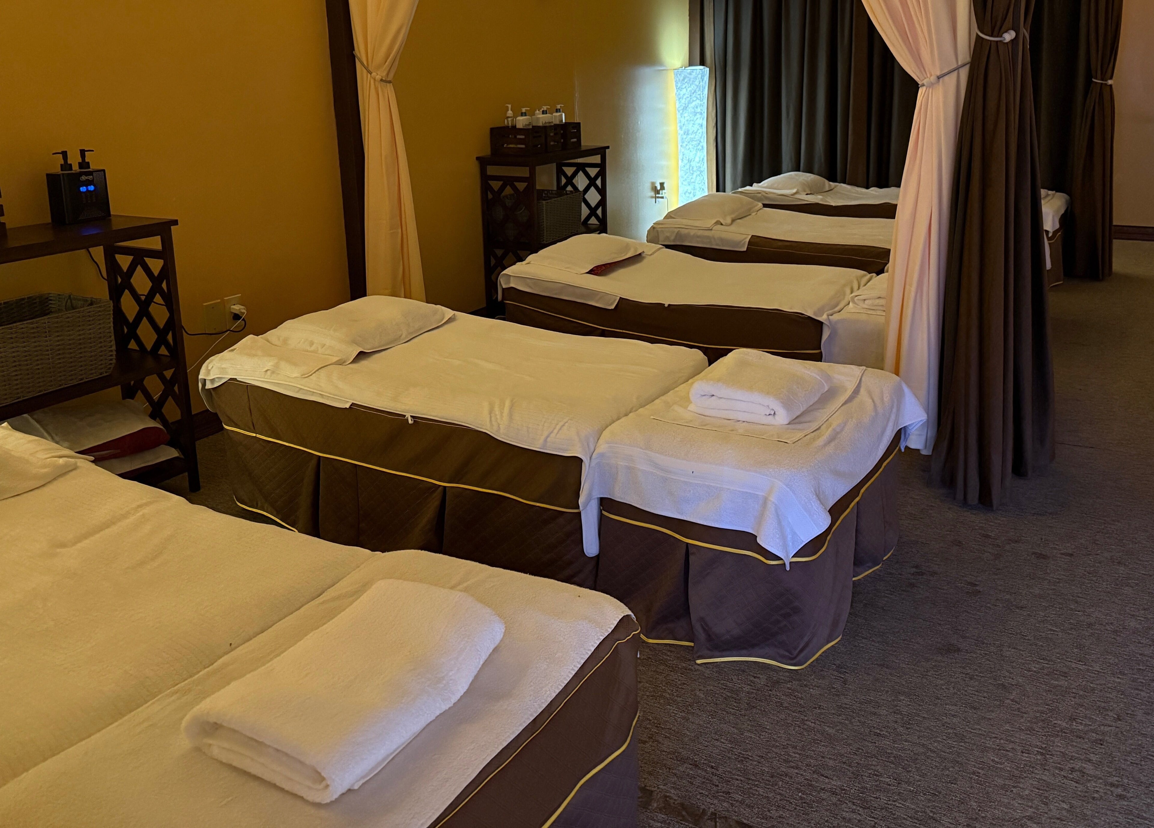 Relaxing massage beds at Spring Cq Spa, Overland Park, Kansas, US, elegantly arranged with warm lighting.