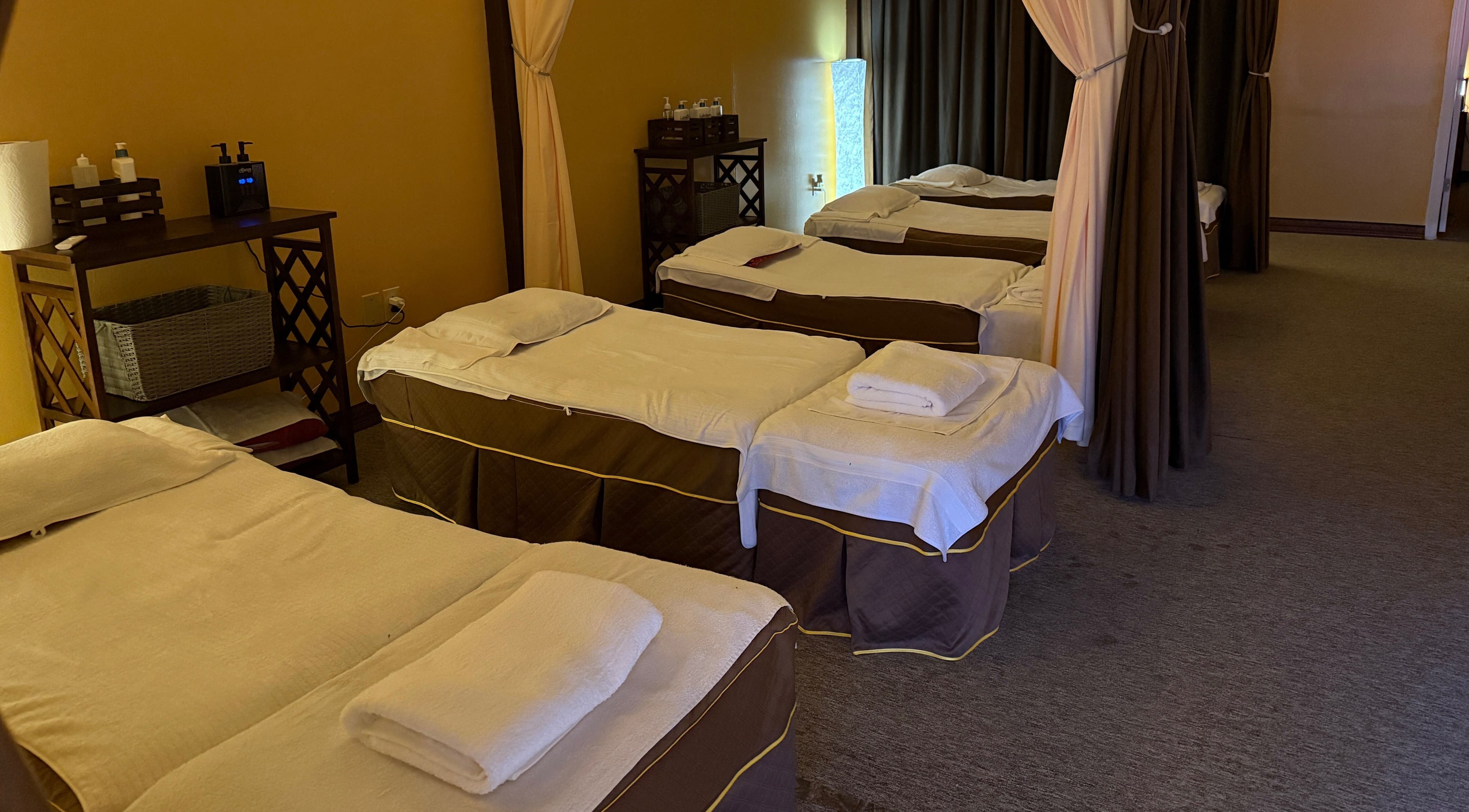 Relaxing massage beds at Spring Cq Spa, Overland Park, Kansas, US, elegantly arranged with warm lighting.
