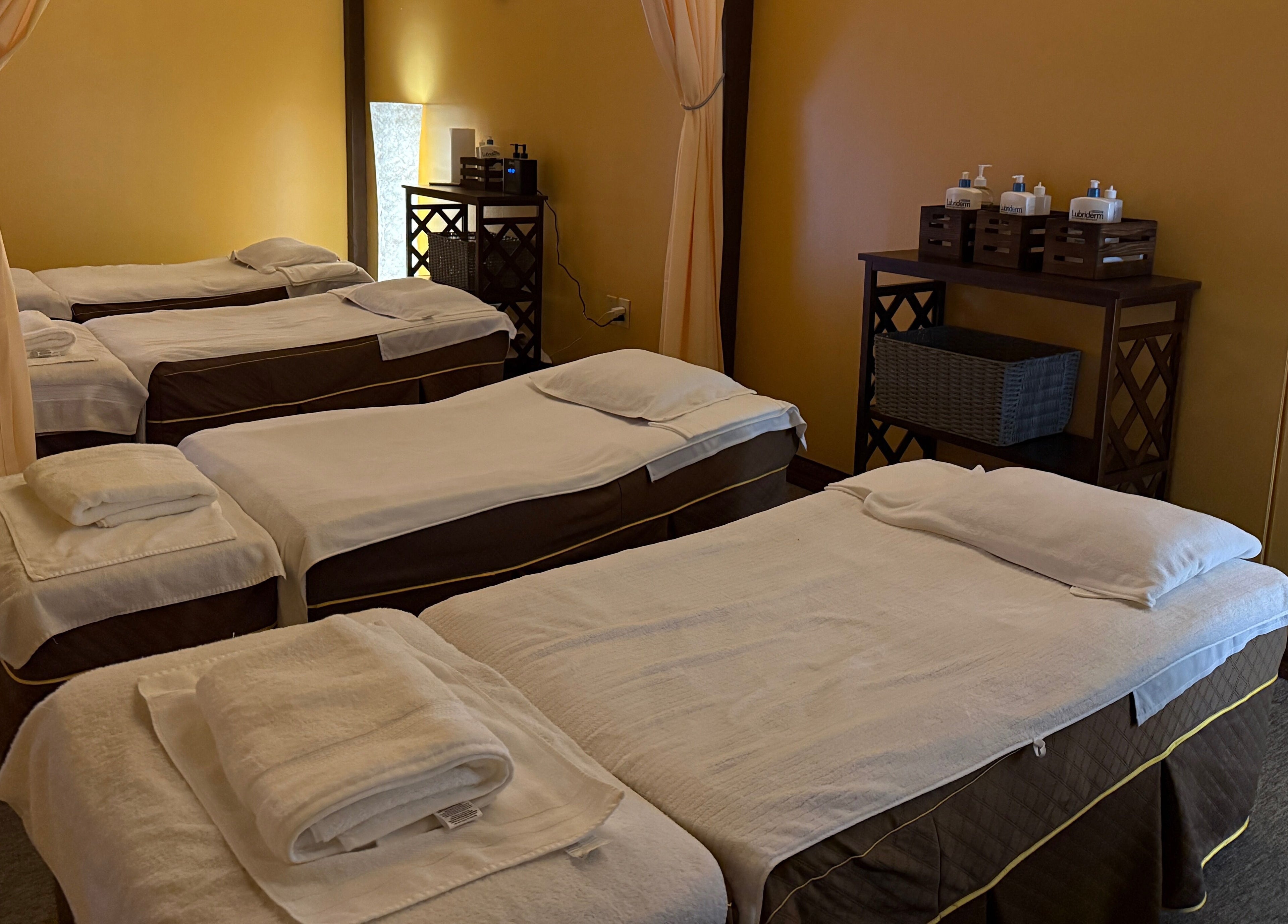 Tranquil massage room at Spring Cq Spa in Overland Park, Kansas, US with neatly prepared beds.
