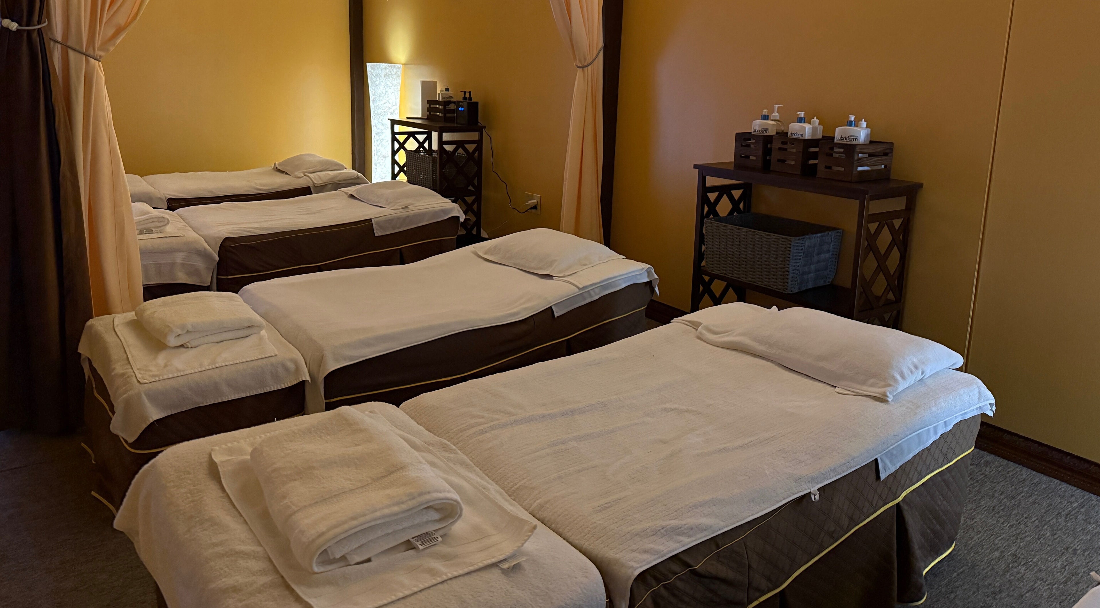 Tranquil massage room at Spring Cq Spa in Overland Park, Kansas, US with neatly prepared beds.