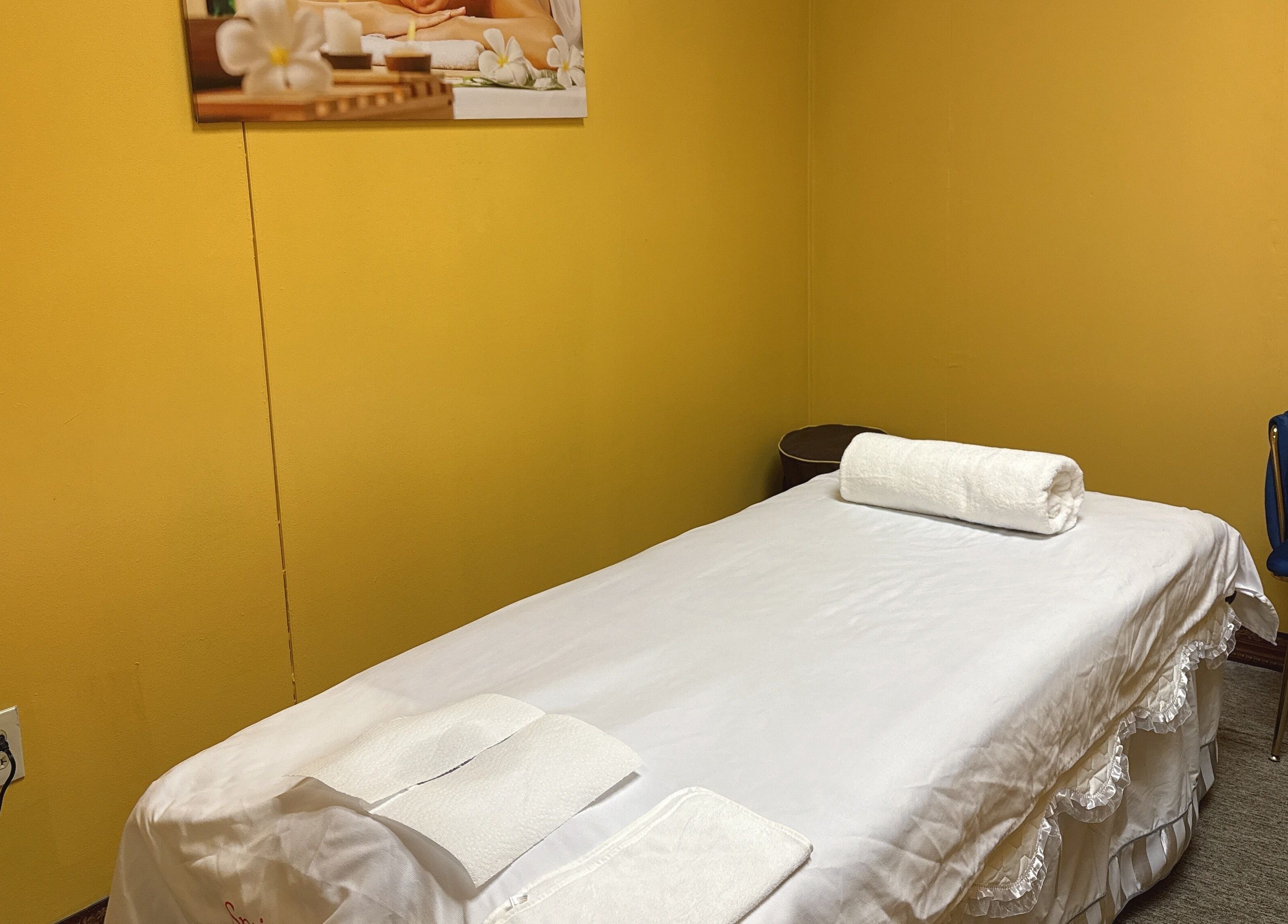 Cozy treatment room at Spring Cq Spa, Overland Park, Kansas, US. Features massage table and calming decor.