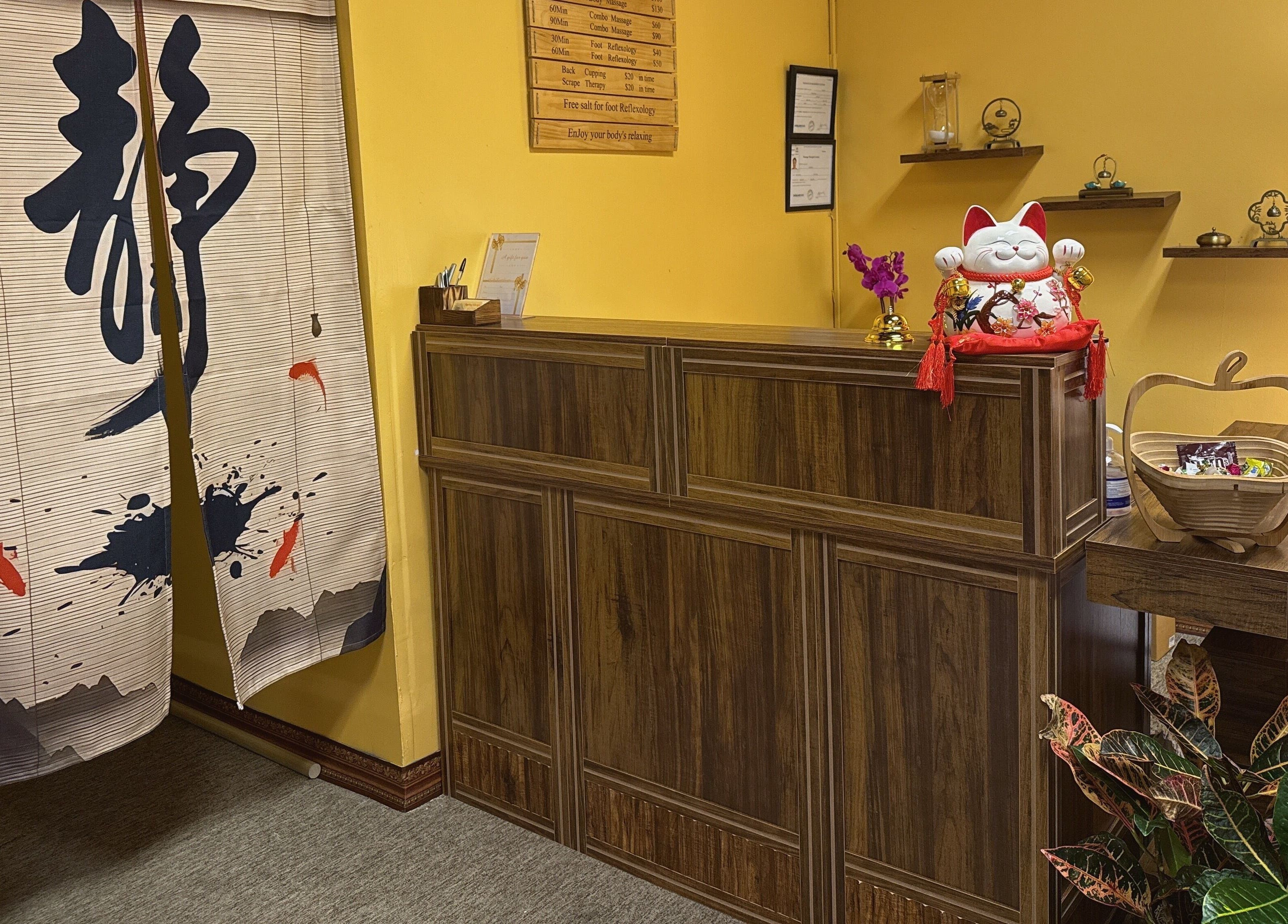 Welcoming reception area of Spring Cq Spa, Overland Park, Kansas, US, featuring wooden desk and decor.