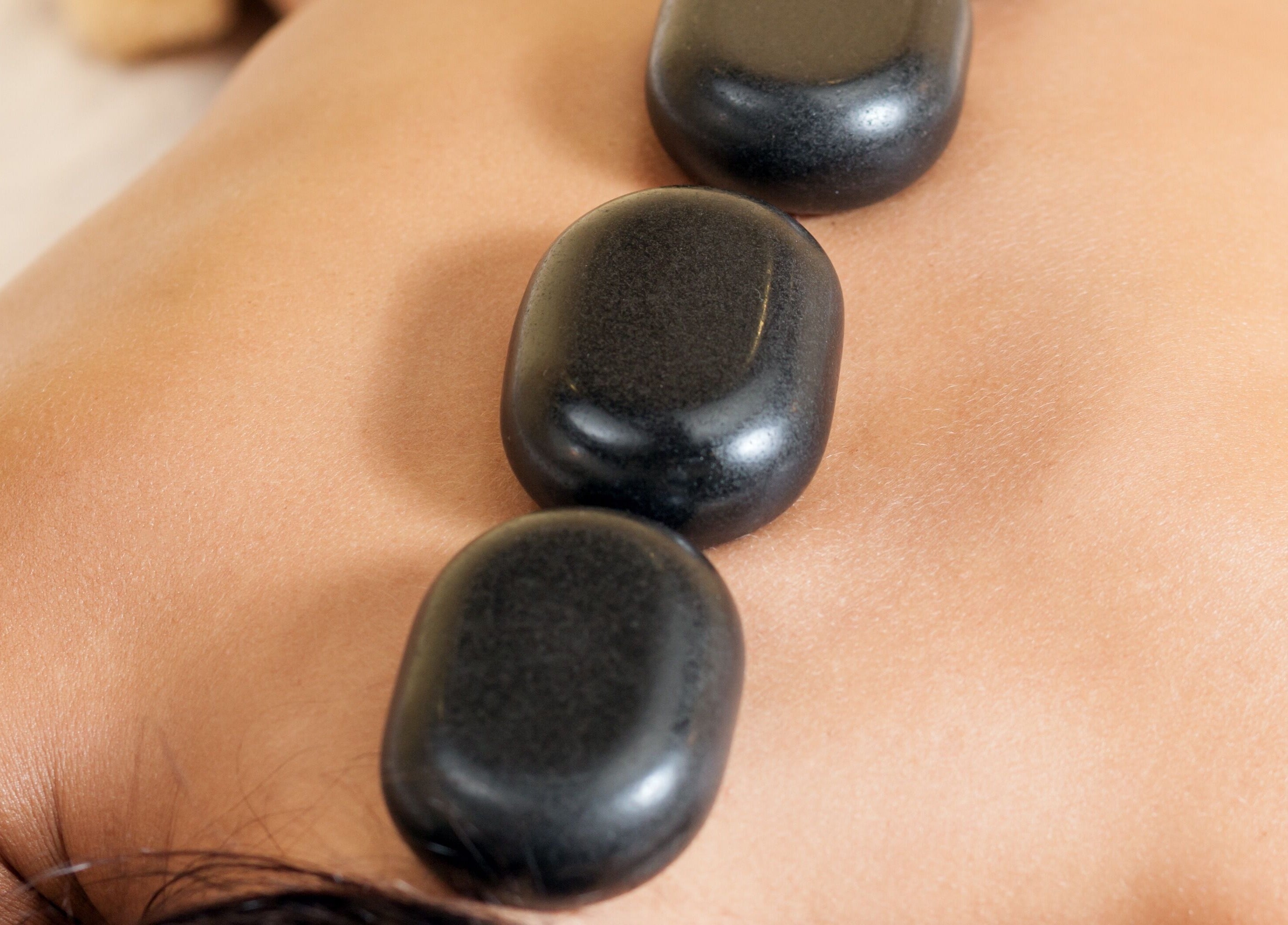 Hot stone therapy at Spring Cq Spa, Overland Park, Kansas, US, promoting relaxation and wellness.