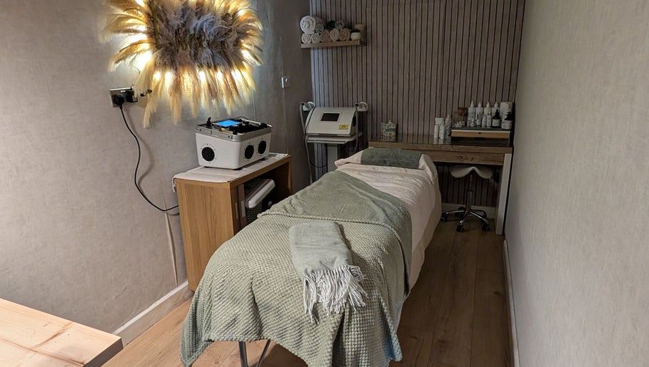 Treatment room at L'abeille Hair & Beauty, Halifax, England, GB. Cozy setup with spa bed and soothing decor.