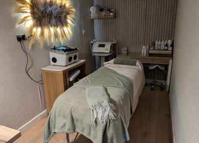 Treatment room at L'abeille Hair & Beauty, Halifax, England, GB. Cozy setup with spa bed and soothing decor.