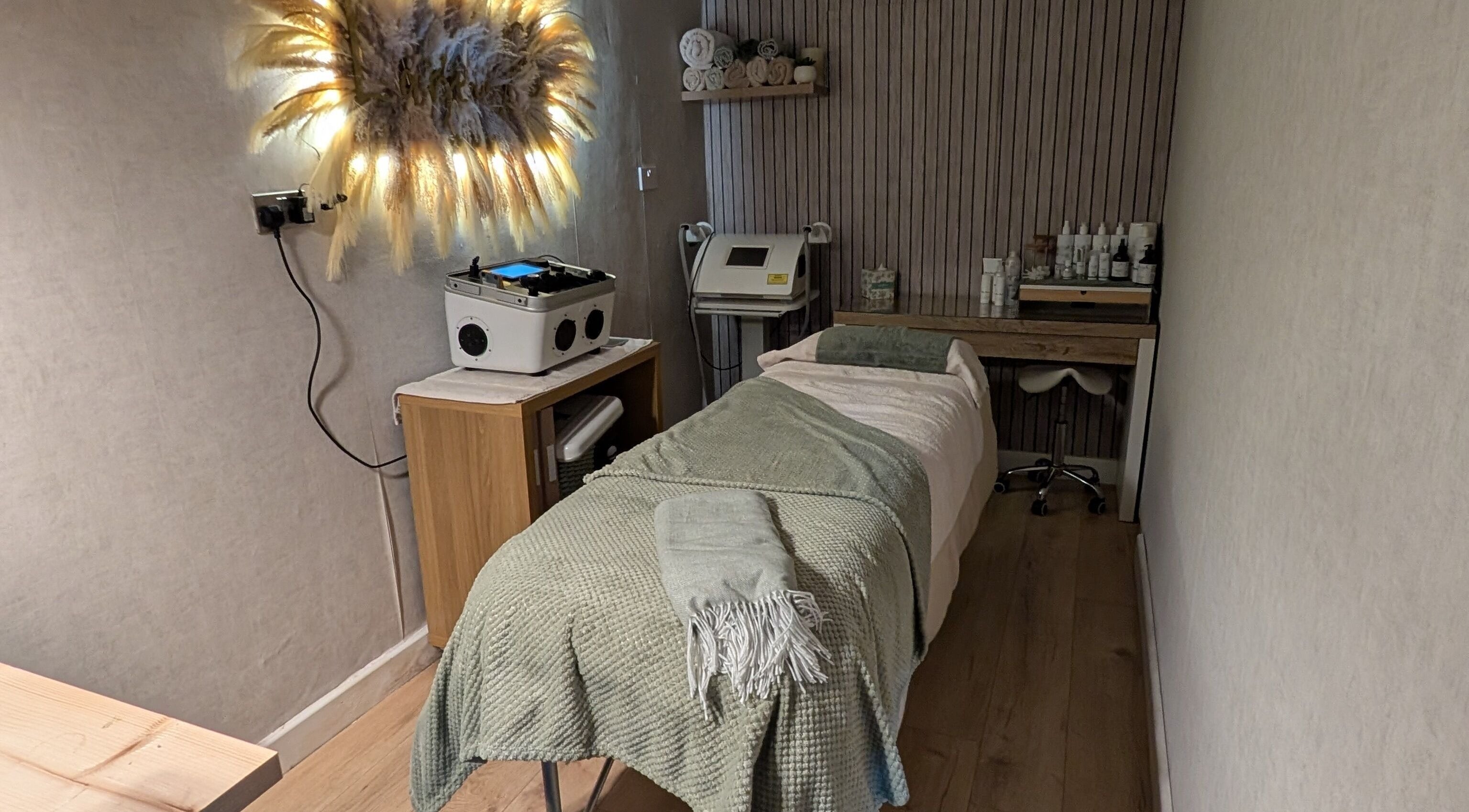 Treatment room at L'abeille Hair & Beauty, Halifax, England, GB. Cozy setup with spa bed and soothing decor.