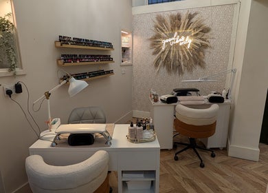 Stylish nail station at L'abeille Hair & Beauty in Halifax, England, GB featuring cozy seating and decor.