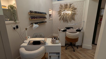 Stylish nail station at L'abeille Hair & Beauty in Halifax, England, GB featuring cozy seating and decor.