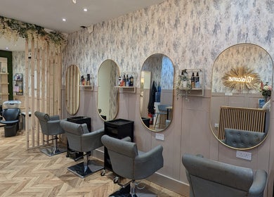 Elegant interior of L'abeille Hair & Beauty in Halifax, England, GB with stylish salon chairs and mirrors.