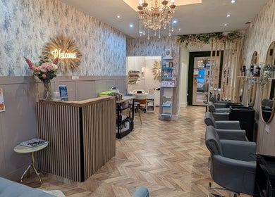 Elegant interior of L'abeille Hair & Beauty in Halifax, England, featuring stylish chairs and decor.