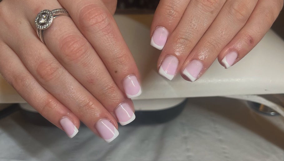Elegant French manicure at Glam By TAM, Stevenage, England, GB showcasing polished pink nails with white tips.