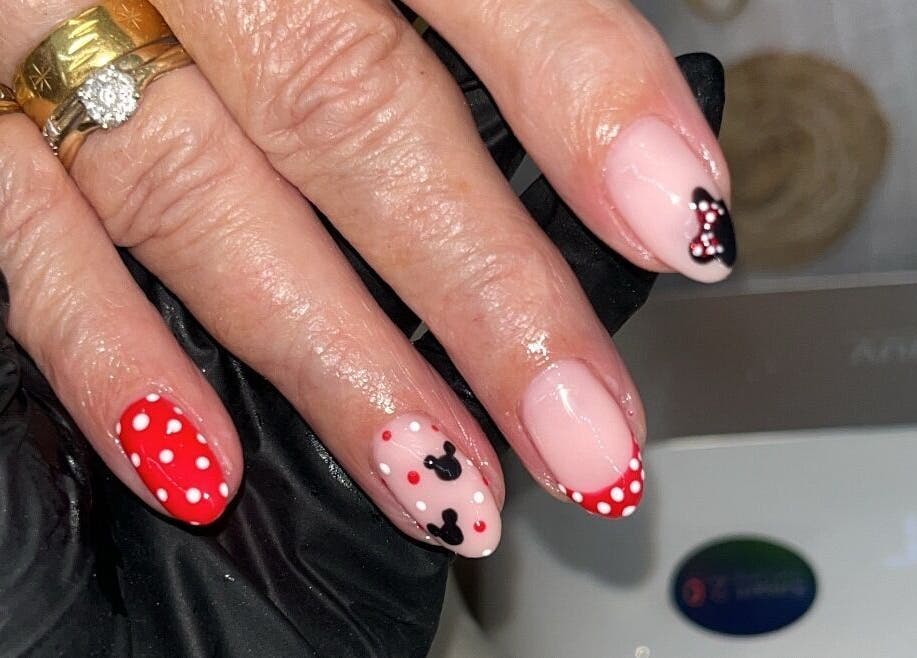 Elegant nail art with polka dots and bows at Glam By TAM, Stevenage, England, GB.