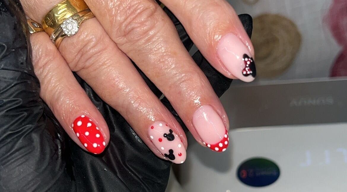 Elegant nail art with polka dots and bows at Glam By TAM, Stevenage, England, GB.