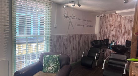 Stylish interior of The Stock Room Hair & Beauty, Norwich, England, with salon chairs and washbasins.