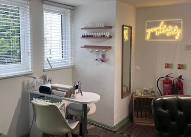 Cozy nail station at The Stock Room Hair & Beauty, Norwich, England, GB with chic decor and neon sign.