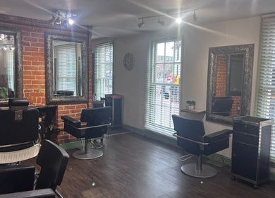 Elegant interior of The Stock Room Hair & Beauty, Norwich, England, GB, showcasing stylish salon chairs and mirrors.