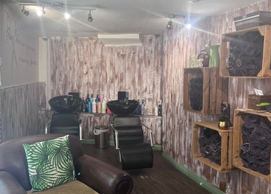 Inside The Stock Room Hair & Beauty, Norwich, England, GB, showcasing a stylish wash station and cozy decor.