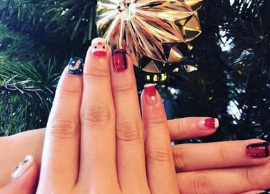 Festive nail art at Momo Nail Spa, Fort Lauderdale, Florida, US, featuring holiday designs and vibrant colors.